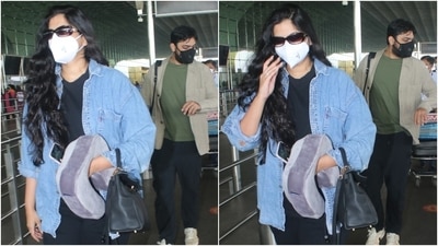 Rhea teamed the outfit with an oversized denim jacket, a top handle bag, chunky black lace-up sneakers, a black top handle bag, a white face mask, and vintage sunglasses. She left her tresses open with the look. (HT Photo/Varinder Chawla)