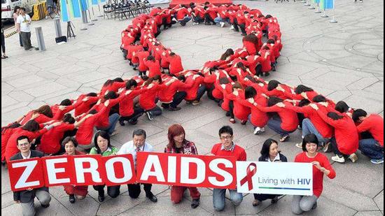 Dozens of volunteers join a human chain in the form of a red ribbon, a symbol of "love and care" for HIV and AIDS carriers worldwide, at a gathering in downtown Taipei ahead of World AIDS Day. The theme of the 2011 global campaign to fight AIDS is 'Getting to Zero'.