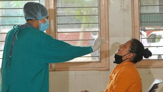 A health worker takes swab samples from a person. (HT File Photo)