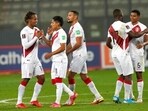Peru's players celebrate at the end of a qualifying soccer match against Venezuela(AP)