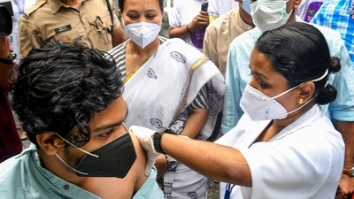 A medic administers a dose of Covid-19 vaccine to a beneficiary in the presence of Kerala health minister Veena George in Thiruvananthapuram. (PTI Photo)