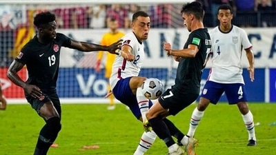 United States defender Sergino Dest (2) battles for the ball with Canada defender Alphonso Davies (19) and Canada midfielder Stephen Eustaquio (7) during the first half of a World Cup soccer qualifier (AP)