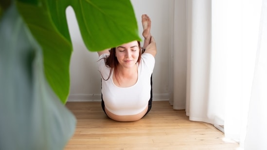2.Dhanurasana or bow pose: Lie down on your stomach, keep your feet slightly apart and almost parallel to your hips while placing your arms on the side of your body. Slowly, fold your knees up and raise your hands backwards to hold your ankles. Inhale, lift your chest off the ground, pull your legs up and stretch it out while feeling the tension on your arms and thighs. Breathe deeply and hold onto the pose for 12-15 seconds before bringing your chest and legs back to the ground slowly.(Photo by madison lavern on Unsplash)