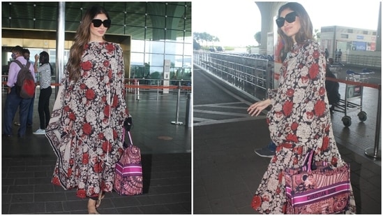Mouni chose a floral printed anarkali suit set to board a flight out of Mumbai. The anarkali kurta, replete with black, off-white and red flowers, featured a cinched waistline, half sleeves, and silver patti border on the neckline.(HT Photo/Varinder Chawla)