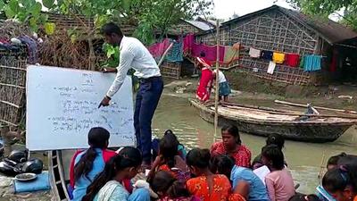 A group of children are being taught in a class organised on a boat in a flooded village at Manihari area, in Bihar’s Katihar. A Central team is assessing the damage caused by floods in Bihar. (ANI Photo)