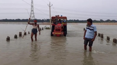 People wade through a flooded area due to heavy rains in Begusarai, Bihar. (ANI) People wade through a flooded area due to heavy rains in Begusarai, Bihar. (ANI)