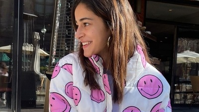 The bomber or cropped puffer jacket came in white base and sported pink smile emojis all over. Leaving her straight blown-out tresses open down her shoulders, Ananya accessorised her look with silver hoop earrings and a funky bracelet. (Instagram/ananyapanday) The bomber or cropped puffer jacket came in white base and sported pink smile emojis all over. Leaving her straight blown-out tresses open down her shoulders, Ananya accessorised her look with silver hoop earrings and a funky bracelet. (Instagram/ananyapanday)