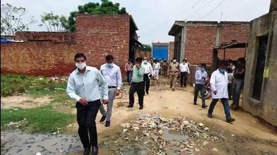 A senior Uttar Pradesh government official taking stock of the dengue situation in a village in Firozabad district. (HT Photo)