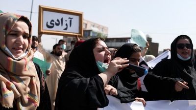 An Afghan woman uses a microphone to chant during the anti-Pakistan protest in Kabul, Afghanistan. (REUTERS)