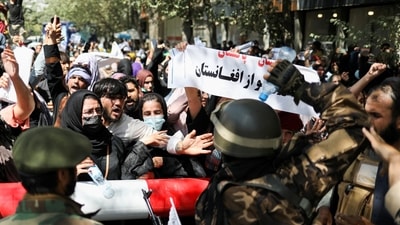 Taliban soldiers stand in front of protesters during the anti-Pakistan protest in Kabul, Afghanistan, September 7, 2021. (WANA via REUTERS)