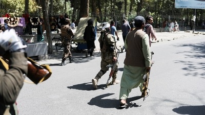 Taliban soldiers walk with their guns during the anti-Pakistan protest in Kabul, Afghanistan. (via REUTERS)