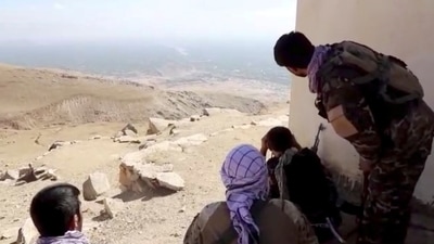 Members of National Resistance Front keep an eye on the surroundings near Panjshir Valley, in Afghanistan. (Reuters File Photo)