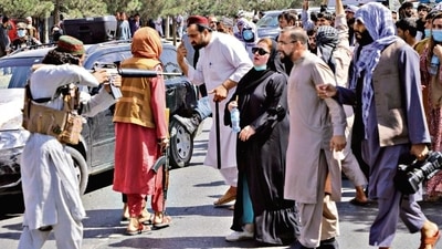 A Taliban fighter points a gun at angry protesters during a demonstration near the Pakistan embassy in Kabul on Tuesday. (Reuters) A Taliban fighter points a gun at angry protesters during a demonstration near the Pakistan embassy in Kabul on Tuesday. (Reuters)