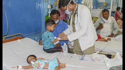 A doctor treats a child suffering from viral fever, at a hospital in Kanpur on Tuesday. (PTI Photo) A doctor treats a child suffering from viral fever, at a hospital in Kanpur on Tuesday. (PTI Photo)