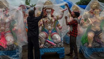 Vendors cover the idols of the Hindu god Ganesha displayed for sale with plastic sheets ahead of the Ganesh Chaturthi festival on the outskirts of Hyderabad on Tuesday. (AFP) Vendors cover the idols of the Hindu god Ganesha displayed for sale with plastic sheets ahead of the Ganesh Chaturthi festival on the outskirts of Hyderabad on Tuesday. (AFP)