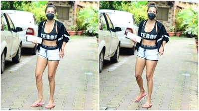 Flaunting her washboard abs, Malaika chose a black Reebok printed crop top featuring a scooped neckline for her workout today. She teamed it with a pair of white shorts adorned with a printed black band. (HT Photo/Varinder Chawla)
