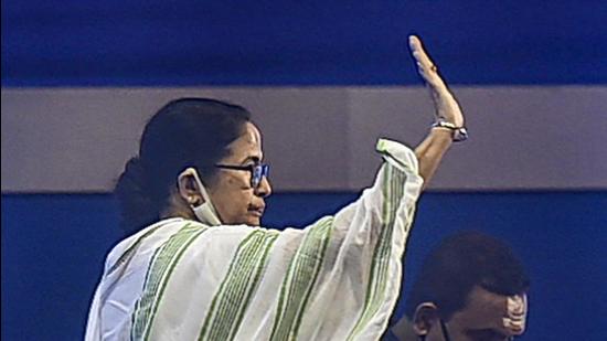 West Bengal chief minister Mamata Banerjee waves during a meeting with different Puja Committees, ahead of 'Durga Puja' festival, in Kolkata on Tuesday. (PTI)