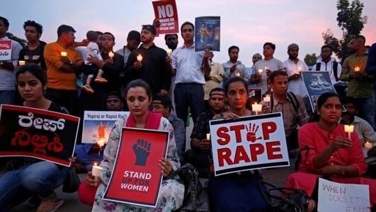 Activists hold a candlelight vigil in Bengaluru to protest the rising incidence of sexual crimes against women across the country.(Reuters Photo) Activists hold a candlelight vigil in Bengaluru to protest the rising incidence of sexual crimes against women across the country.(Reuters Photo)