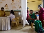 A healthcare worker inoculates a beneficiary against Covid-19, at a vaccination centre in Mumbai on Tuesday.