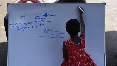 Children, mostly first generation learners, attend the thrice a week special class organised by NGO Towards Future, at a temporary market place in Kashinathpur Bazar, Rajarhat, West Bengal, on September 4. Due to the ongoing pandemic, schools in West Bengal haven’t reopened yet and students primarily depend on virtual learning and online education. (Samir Jana / HT Photo) Children, mostly first generation learners, attend the thrice a week special class organised by NGO Towards Future, at a temporary market place in Kashinathpur Bazar, Rajarhat, West Bengal, on September 4. Due to the ongoing pandemic, schools in West Bengal haven’t reopened yet and students primarily depend on virtual learning and online education. (Samir Jana / HT Photo)