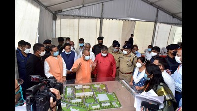 Uttar Pradesh chief minister Yogi Adityanath looking at the model of the state university in Aligarh on Wednesday (HT photo) Uttar Pradesh chief minister Yogi Adityanath looking at the model of the state university in Aligarh on Wednesday (HT photo)