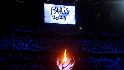 The Tokyo 2020 Olympics Closing Ceremony - Olympic Stadium, Tokyo, Japan - August 8, 2021. The Olympic torch and cauldron are seen with Paris 2024 displayed on the big screen during the closing ceremony. (REUTERS)