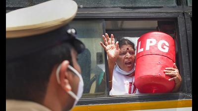A Congress Mahila Morcha member inside a police van after police detained her during a protest against the hike in fuel and LPG prices, in Bengaluru, Wednesday. (PTI Photo)