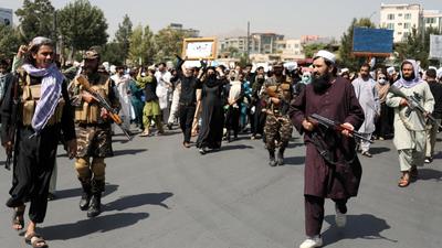 Taliban soldiers stand in front of protesters during the anti-Pakistan protest in Kabul, Afghanistan, on Tuesday. The US has questioned over the lack of diversity in the composition of the caretaker government in Afghanistan announced by the Taliban. (REUTERS) Taliban soldiers stand in front of protesters during the anti-Pakistan protest in Kabul, Afghanistan, on Tuesday. The US has questioned over the lack of diversity in the composition of the caretaker government in Afghanistan announced by the Taliban. (REUTERS)