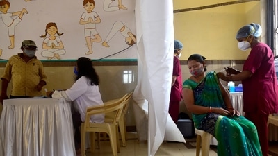 A healthcare worker inoculates a beneficiary against Covid-19, at a vaccination centre in Mumbai on Tuesday. (Anshuman Poyrekar/HT Photo)