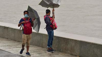 People at Marine Drive during heavy rain in Mumbai. (File photo) People at Marine Drive during heavy rain in Mumbai. (File photo)