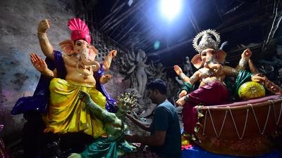 An artist gives the finishing touches to an idol of Ganesha with a figure depicting a coronavirus at a workshop ahead of the Ganesh Chaturthi festival. (Representational image/AFP) An artist gives the finishing touches to an idol of Ganesha with a figure depicting a coronavirus at a workshop ahead of the Ganesh Chaturthi festival. (Representational image/AFP)