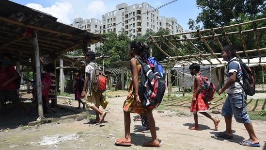 Children arrive to attend the thrice a week special class organised by NGO Towards Future, at a temporary market place in Kashinathpur Bazar, Rajarhat, West Bengal, on September 4. NGO Towards Future started these special classes to help underprivileged children belonging to families of socio-economic background like daily wage workers, masons, auto drivers, bus conductors, security guards and hawkers.(Samir Jana / HT Photo)