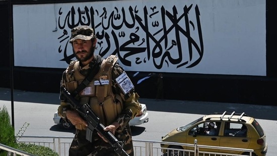 A member of the Taliban Fateh fighter, a ‘special forces’ unit, stands guard outside the US embassy in Afghanistan displaying a Taliban flag in the wall in Kabul on Wednesday. (AFP) (HT_PRINT)