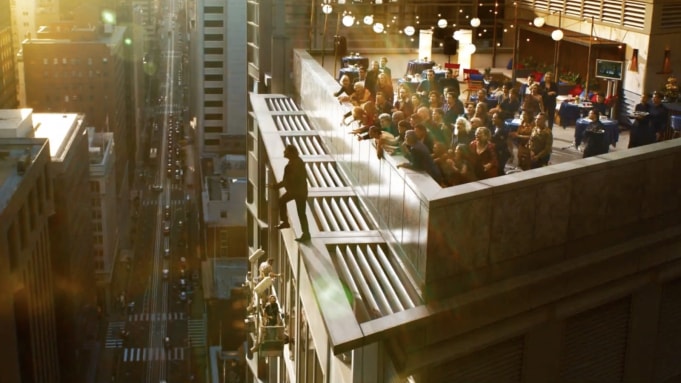 A character who seems to be Neo taking a step off a tall building. A character who seems to be Neo taking a step off a tall building.
