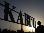 Taliban soldiers stand in front of a sign at the international airport in Kabul, Afghanistan, September 9, 2021.