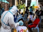 A healthcare worker takes a nasal swab sample from a person for a coronavirus disease (Covid-19) test, at a temple near Klong Toey slum community in Bangkok, Thailand&nbsp;
