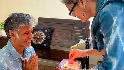 In this still, one of Milind Soman's sisters can be seen doing the raksha bandhan rituals before tying the rakhi. (Instagram/@milindrunning)