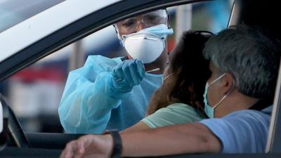 A healthcare worker at a drive-thru site set up by Miami-Dade and Nomi Health in Tropical Park administers a Covid test in Miami, Florida, US. The Joe Biden administration is trying to get a grip on the response to the pandemic, which has come unstuck in recent weeks. (AFP) A healthcare worker at a drive-thru site set up by Miami-Dade and Nomi Health in Tropical Park administers a Covid test in Miami, Florida, US. The Joe Biden administration is trying to get a grip on the response to the pandemic, which has come unstuck in recent weeks. (AFP)