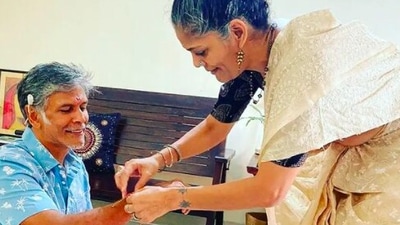 Milind Soman gives his hand forward for his third sister to tie the holy thread, rakhi. (Instagram/@milindrunning)