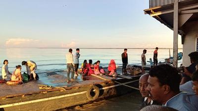 People rescued from a capsized ferry in the Brahmaputra river resting near Nimati Ghat, in Jorhat in Assam, Wednesday. (AP) People rescued from a capsized ferry in the Brahmaputra river resting near Nimati Ghat, in Jorhat in Assam, Wednesday. (AP)