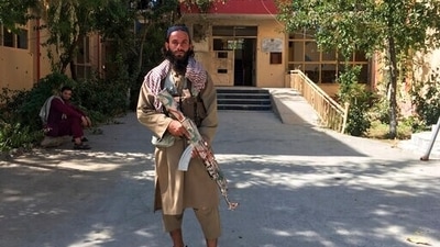A Taliban fighter stands near a building in Panjshir province, northeastern of Afghanistan, on Wednesday. (AP Photo)