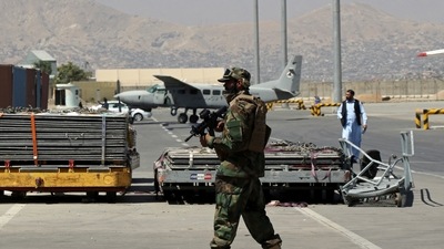 A Taliban soldier walks on the tarmac at Hamid Karzai International Airport in Kabul, Afghanistan. (AP file photo)