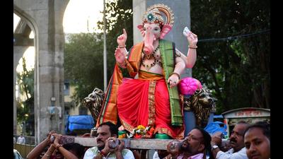 Devotees carry the idol of Lord Ganesh to a pandal, on the eve of Ganesh Chaturthi. (Bhushan Koyande/ HT) Devotees carry the idol of Lord Ganesh to a pandal, on the eve of Ganesh Chaturthi. (Bhushan Koyande/ HT)