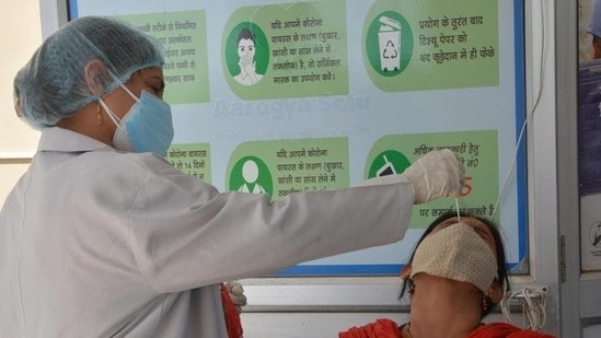 A health worker conducting a Covid-19 test