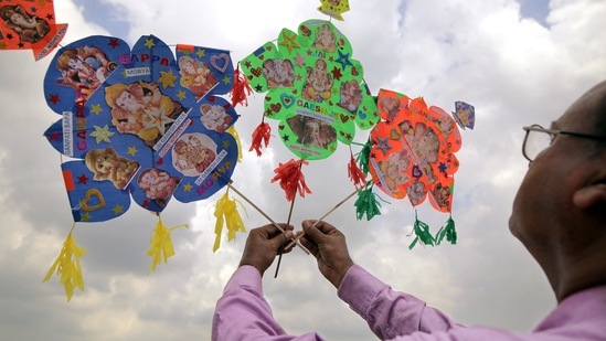 Kite maker Jagmohan Kanojia holds the kites illustrated with Lord Ganesha on the eve of the Ganesh Chaturthi festival, in Amritsar.(ANI)