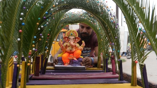 An artisan displays an idol of Lord Ganesha at roadside stall ahead of the Ganesh Chaturthi festival in Hyderabad on September 9.(AFP)