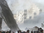 A group of firefighters stand on the street near the destroyed World Trade Centre in New York on September 11, 2001. Stapleton, then a freelancer for Reuters, took a few frames of a group of people emerging from what remained of the building's lobby.(Shannon Stapleton / REUTERS)