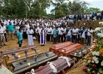 A priest conducts religious rituals during a mass burial for Easter Sunday bomb blast victims in Negombo, Sri Lanka.&nbsp;