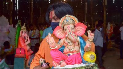 A devotee carries an idol of Lord Ganesha during Ganesh Chaturthi festival in Bengaluru on Friday. (PTI) A devotee carries an idol of Lord Ganesha during Ganesh Chaturthi festival in Bengaluru on Friday. (PTI)