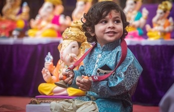 A child sits near idol of Ganesha with the musical instrument Manjira in hand on the eve of Ganesh Chaturthi, at Kasba Peth, in Pune. (Pratham Gokhale/Hindustan Times) A child sits near idol of Ganesha with the musical instrument Manjira in hand on the eve of Ganesh Chaturthi, at Kasba Peth, in Pune. (Pratham Gokhale/Hindustan Times)